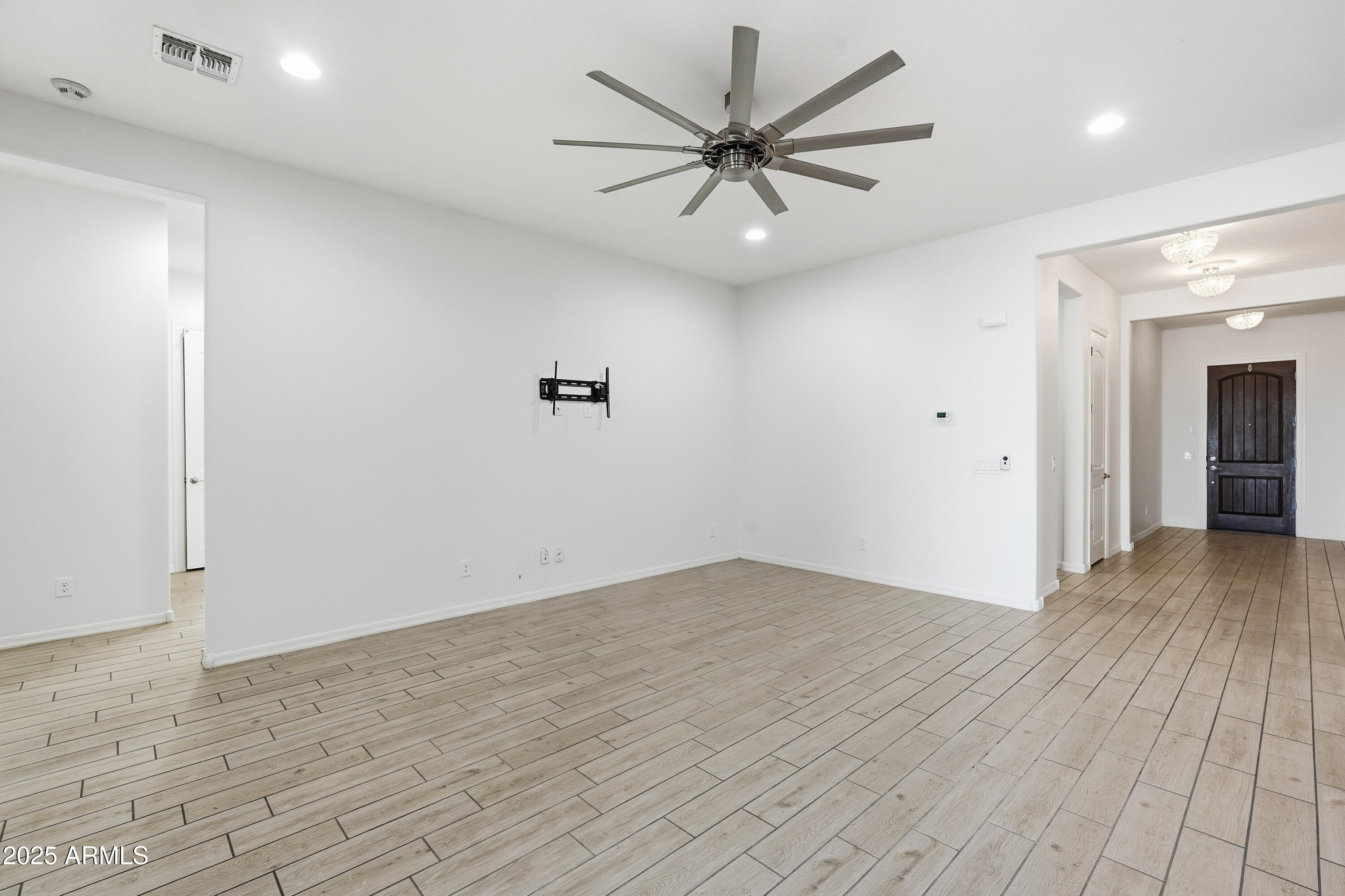 1432 East Pedro Road Phoenix, AZ 85042 - Photo 12 of 52 an empty room with wooden floor and windows