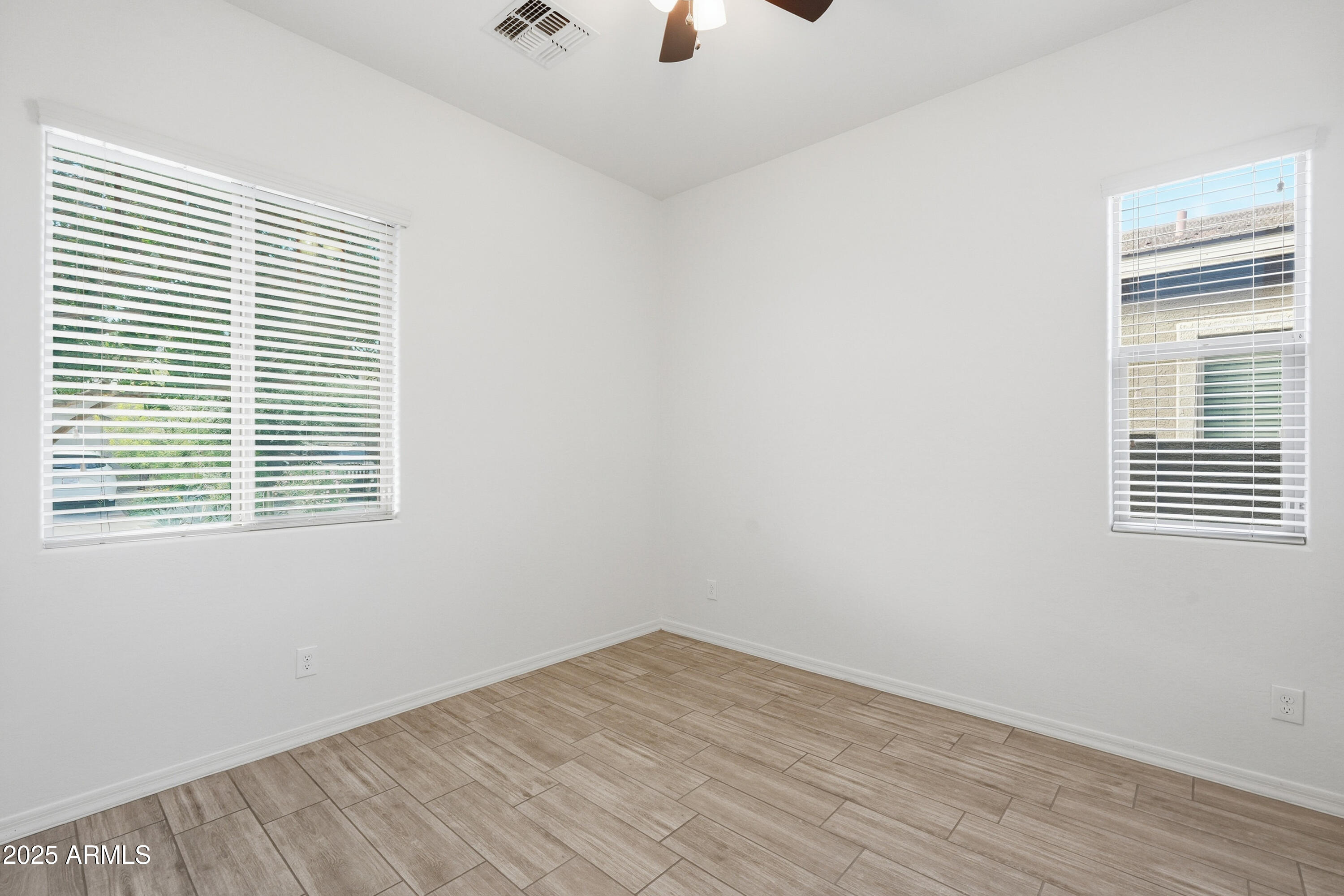 1432 East Pedro Road Phoenix, AZ 85042 - Photo 15 of 52 wooden floor in an empty room with a window