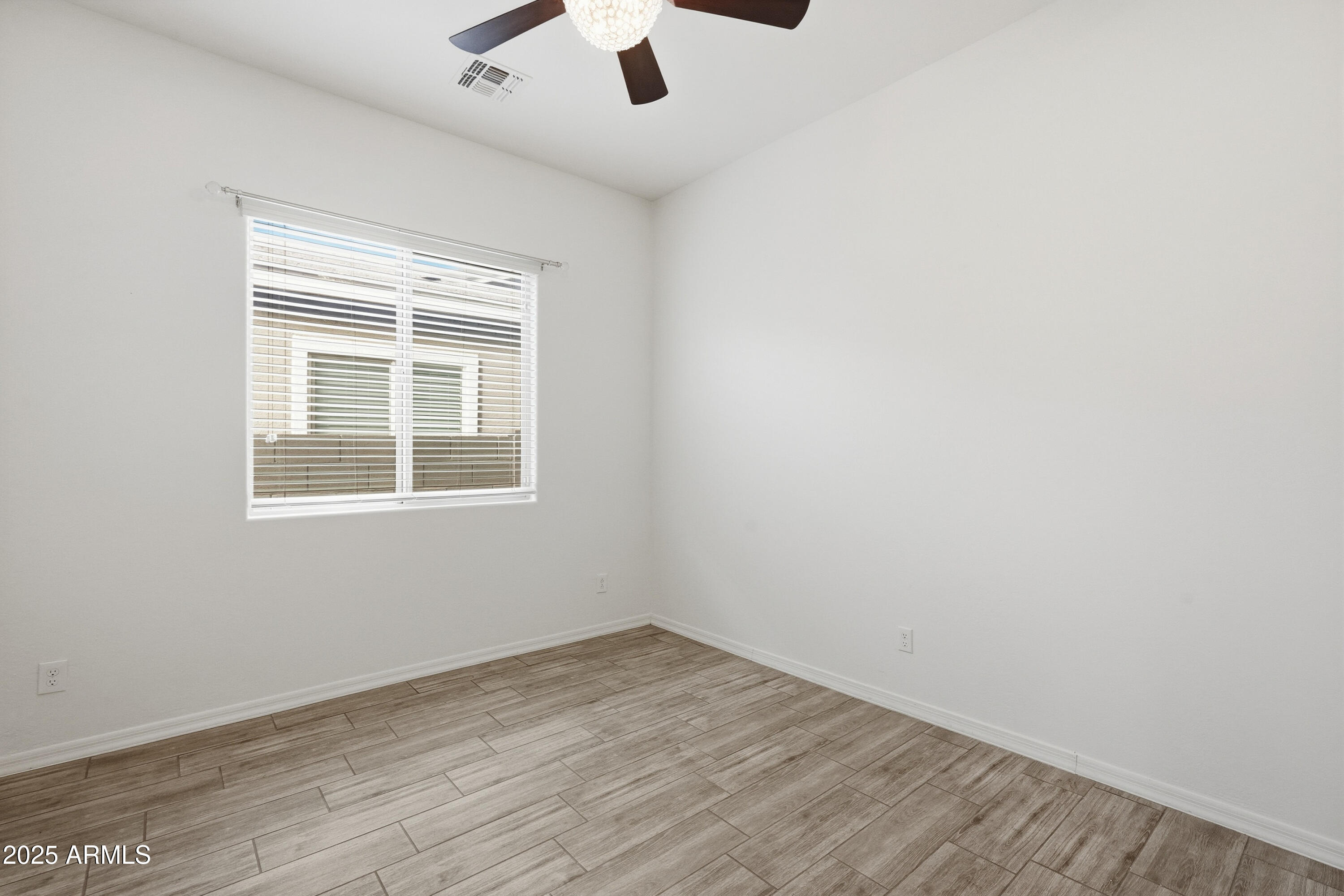 1432 East Pedro Road Phoenix, AZ 85042 - Photo 20 of 52 an empty room with a window and a ceiling fan