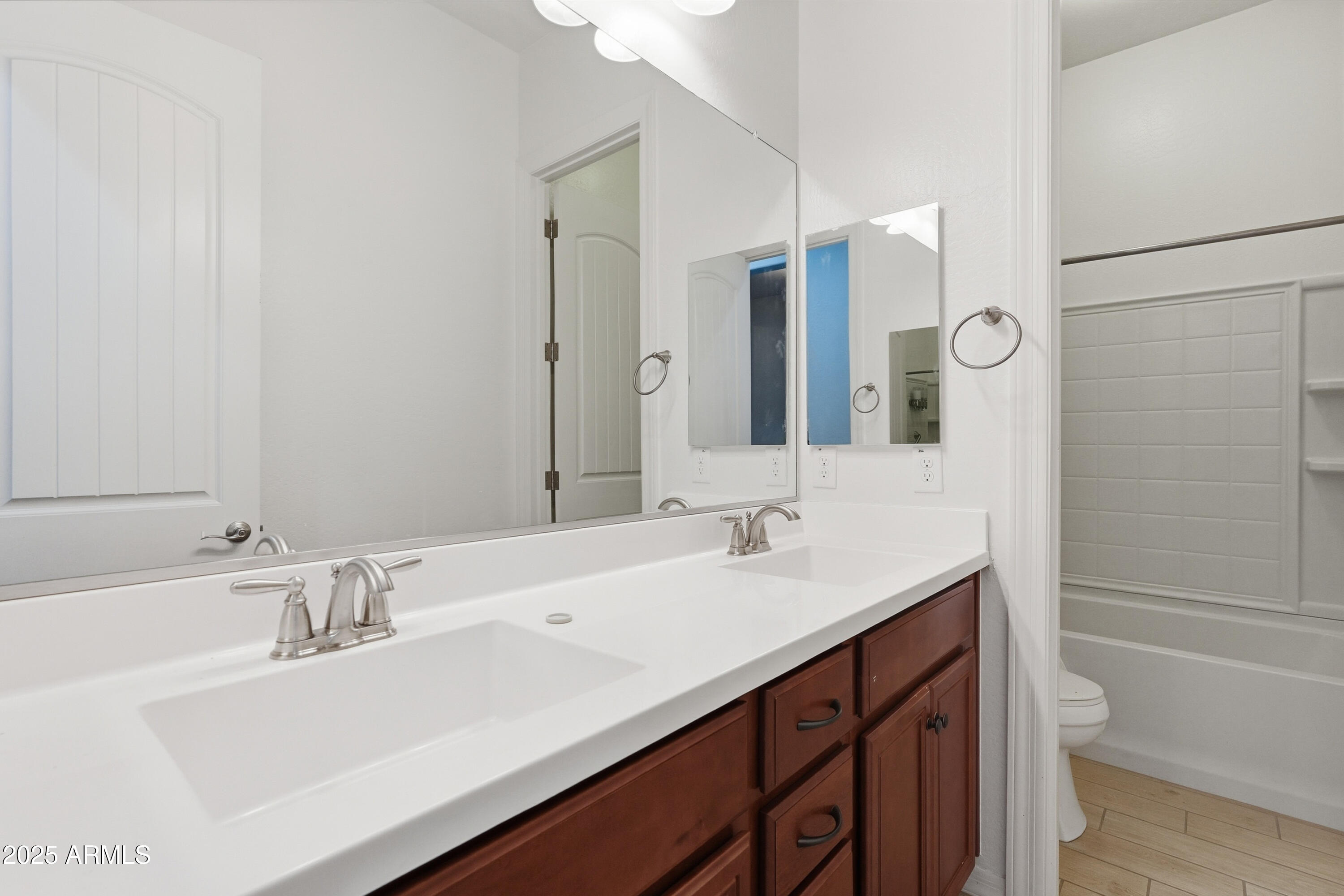 1432 East Pedro Road Phoenix, AZ 85042 - Photo 23 of 52 a bathroom with a sink a toilet a mirror and shower