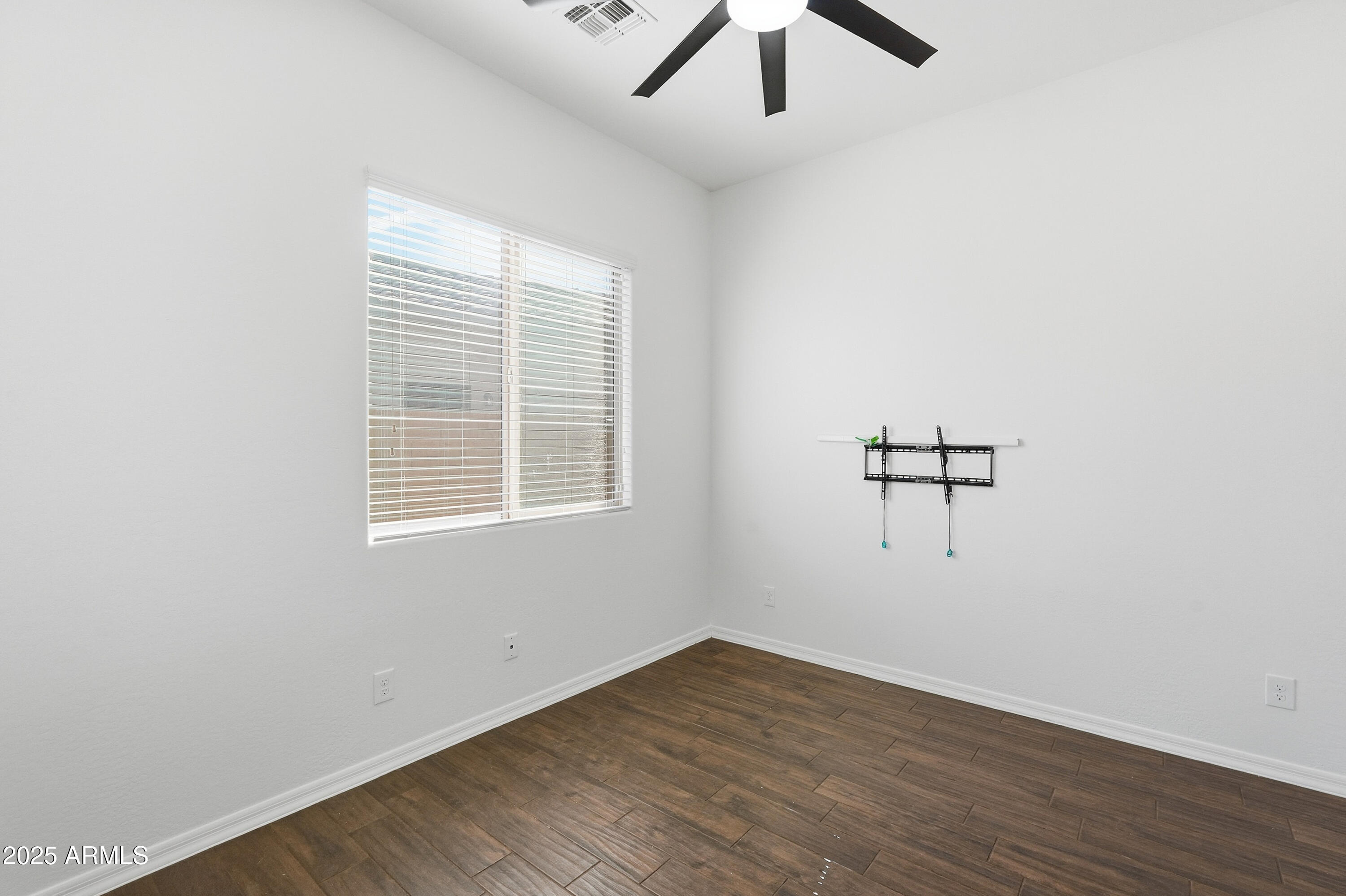 1432 East Pedro Road Phoenix, AZ 85042 - Photo 24 of 52 an empty room with a window and a ceiling fan