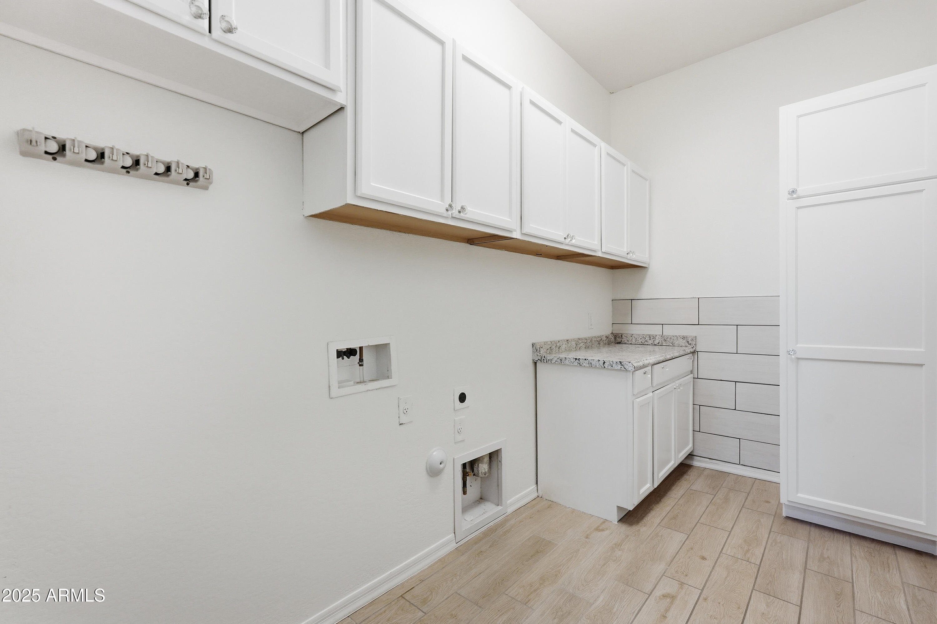 1432 East Pedro Road Phoenix, AZ 85042 - Photo 34 of 52 a kitchen with cabinets appliances and a wooden floor