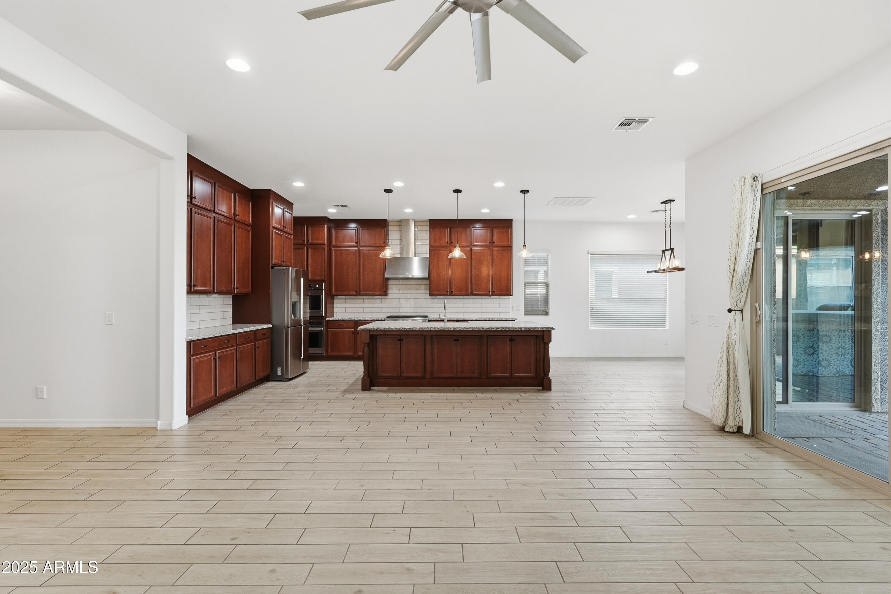 1432 East Pedro Road Phoenix, AZ 85042 - Photo 4 of 52 a living room with stainless steel appliances kitchen island granite countertop a refrigerator and a sink