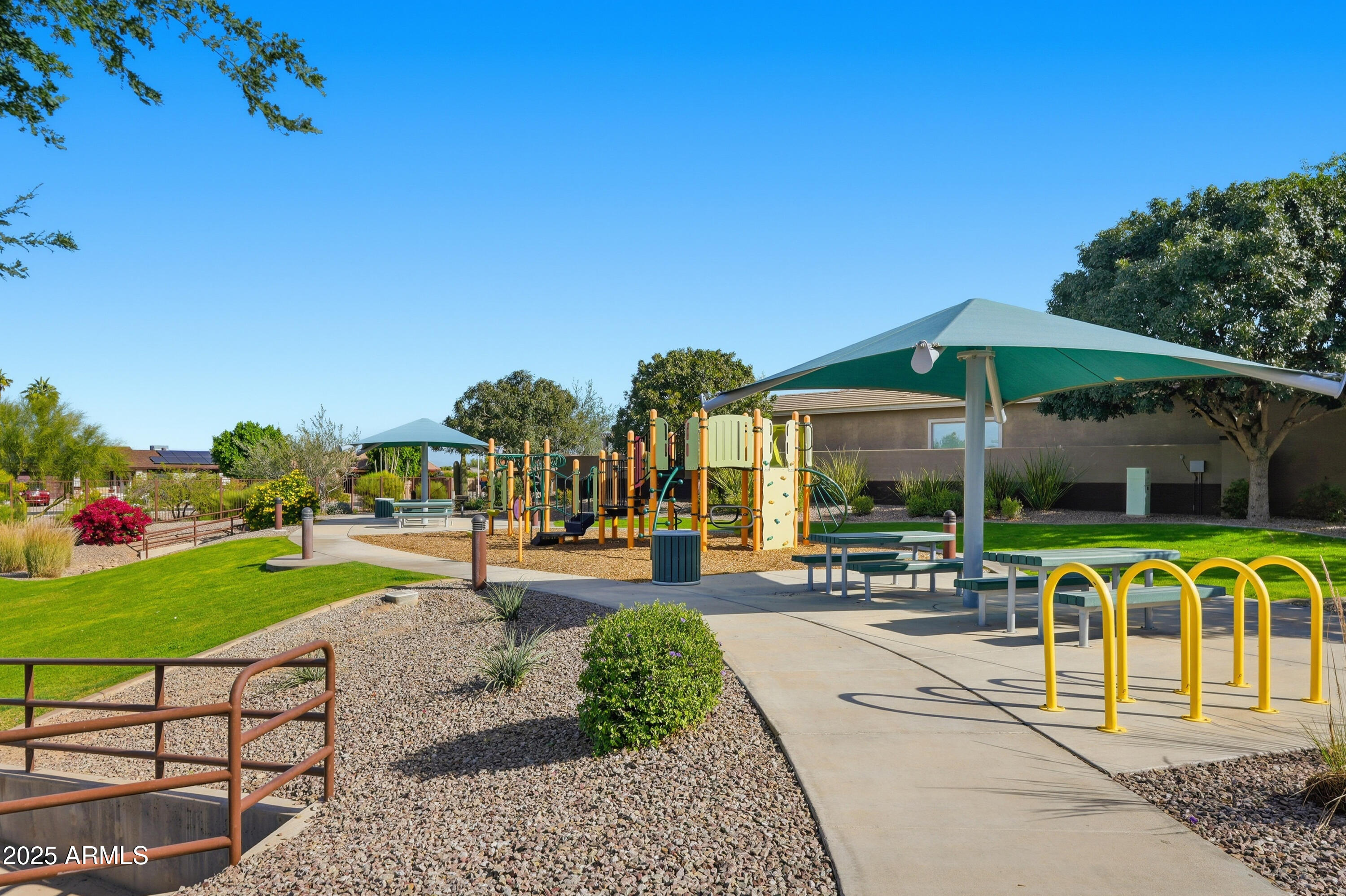 1432 East Pedro Road Phoenix, AZ 85042 - Photo 50 of 52 a view of a patio with a table and chairs under an umbrella