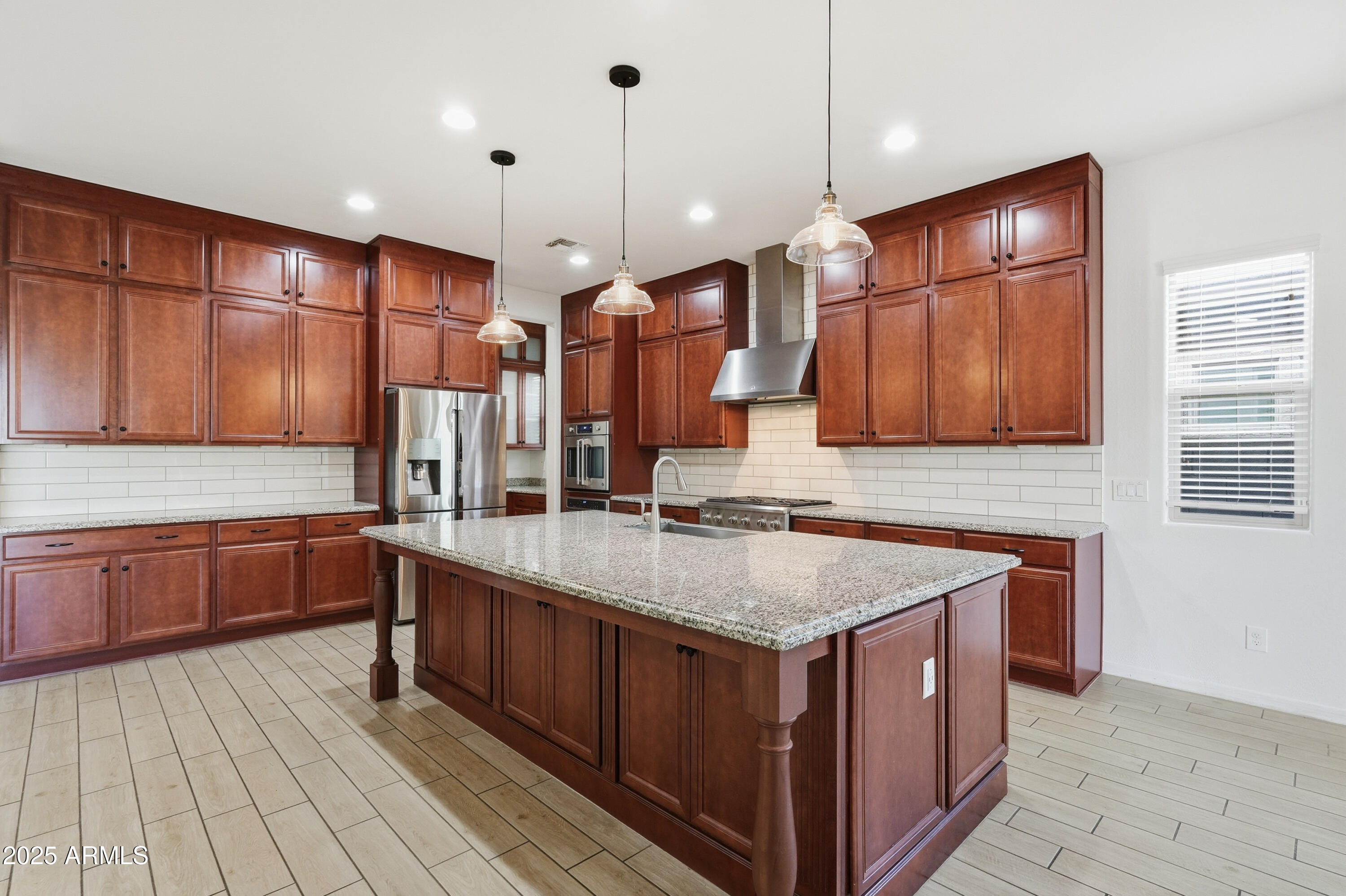 1432 East Pedro Road Phoenix, AZ 85042 - Photo 5 of 52 a kitchen with stainless steel appliances granite countertop wooden cabinets sink and stove