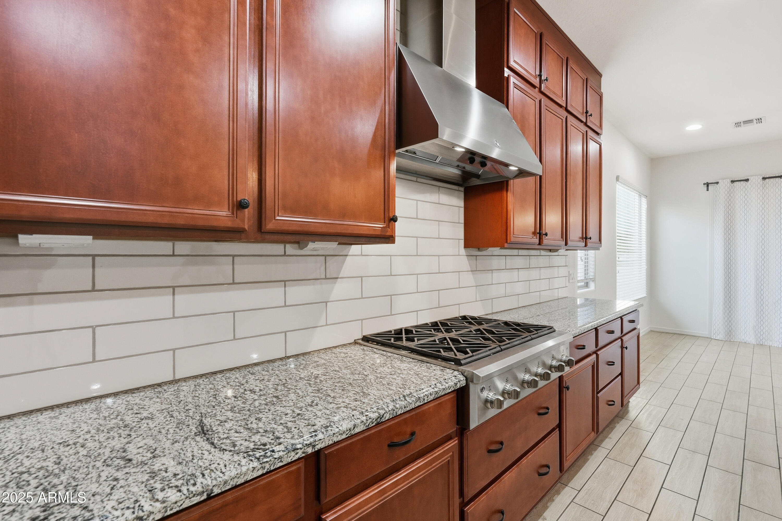 1432 East Pedro Road Phoenix, AZ 85042 - Photo 6 of 52 a kitchen with stainless steel appliances granite countertop a stove a sink and dishwasher