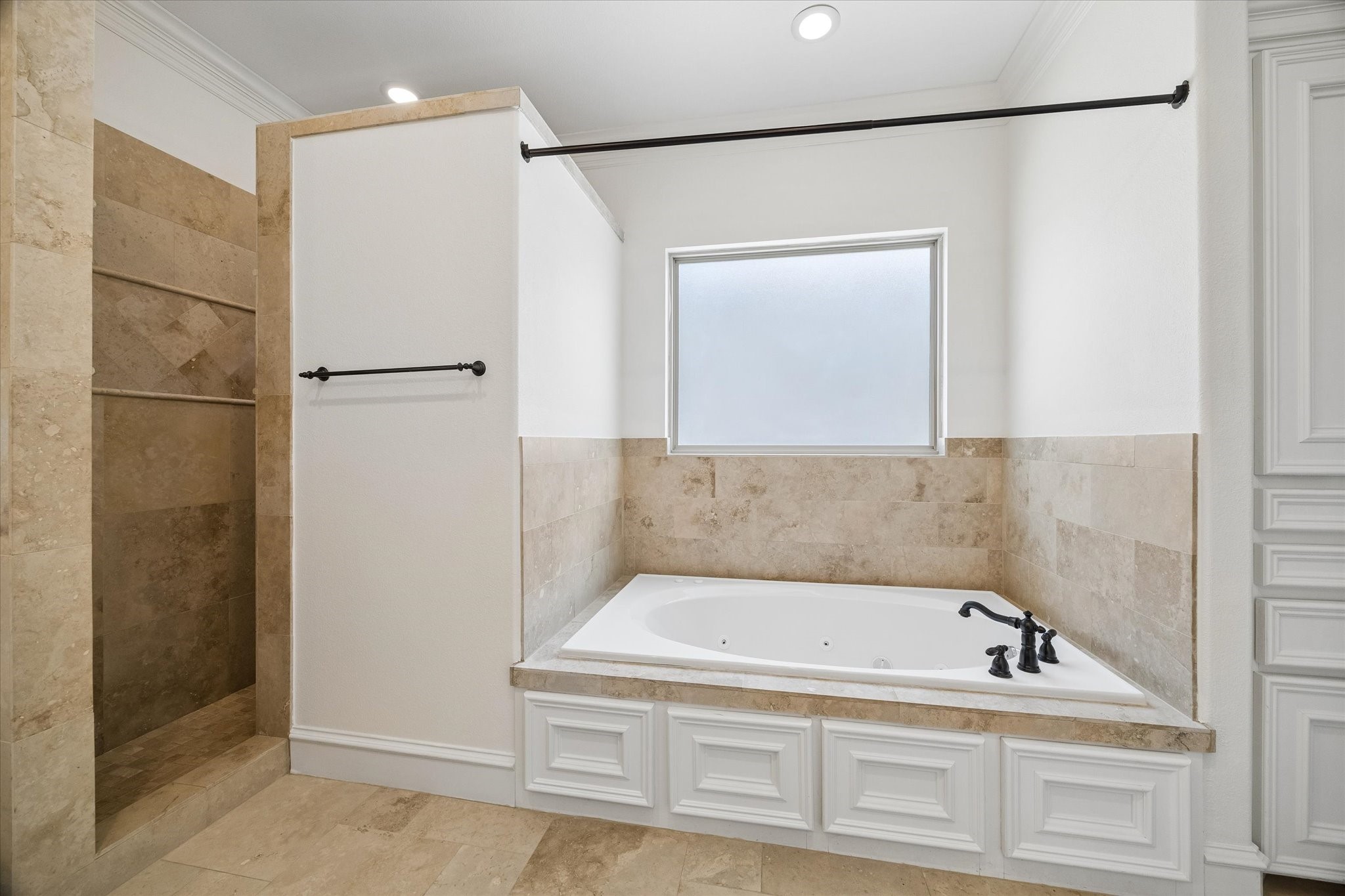 5334 Inker Street Houston, TX 77007 - Photo 17 of 39 Luxurious primary bathroom featuring a deep-soaking jetted tub and a spacious walk-in shower, offering the perfect combination of relaxation and daily efficiency to accommodate busy mornings.