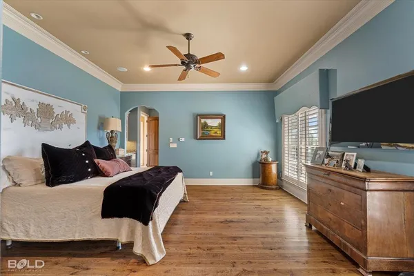 a bedroom with furniture and a flat screen tv