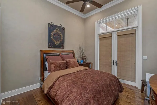 a bedroom with a bed and wooden floor