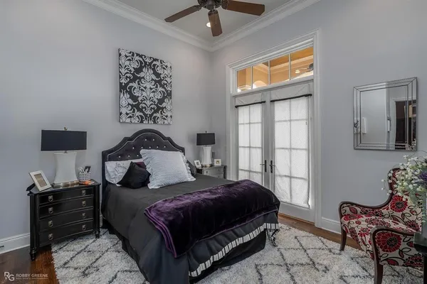 a bedroom with a bed and wooden floor