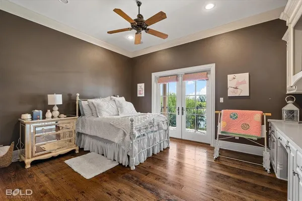 a bedroom with furniture and a large window