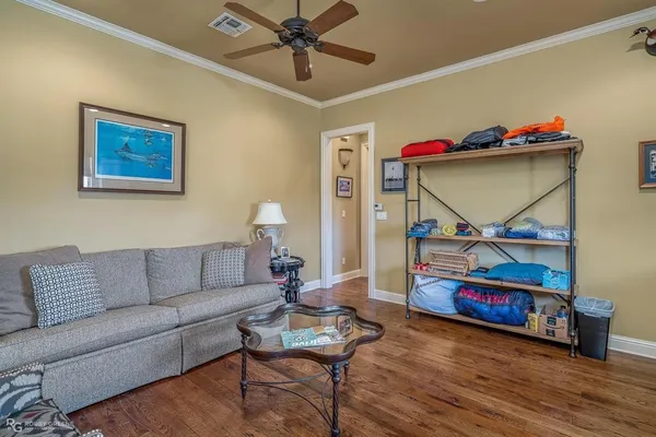 a living room with furniture and wooden floor