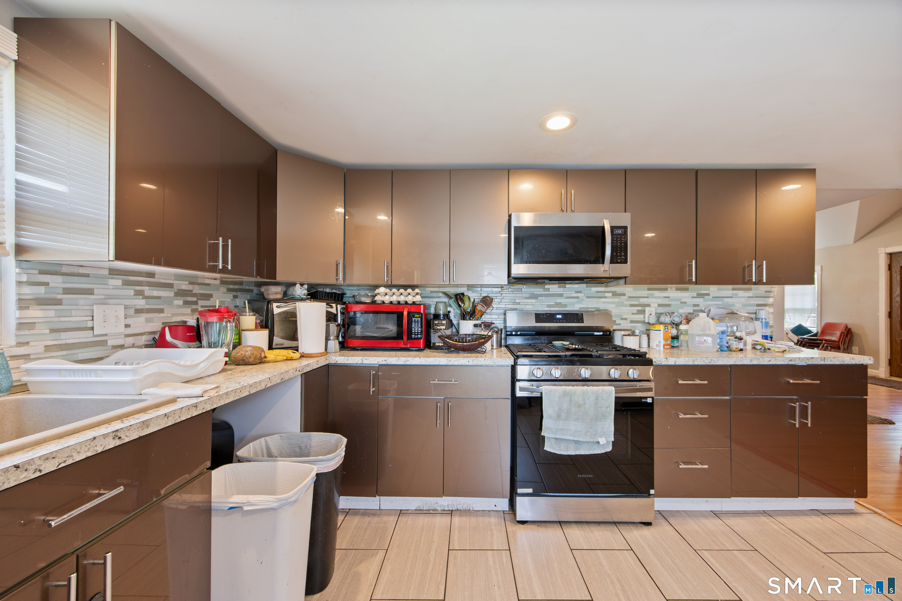 277 South Main Street Torrington, CT 06790 - Photo 17 of 26 a kitchen with a sink cabinets and stainless steel appliances