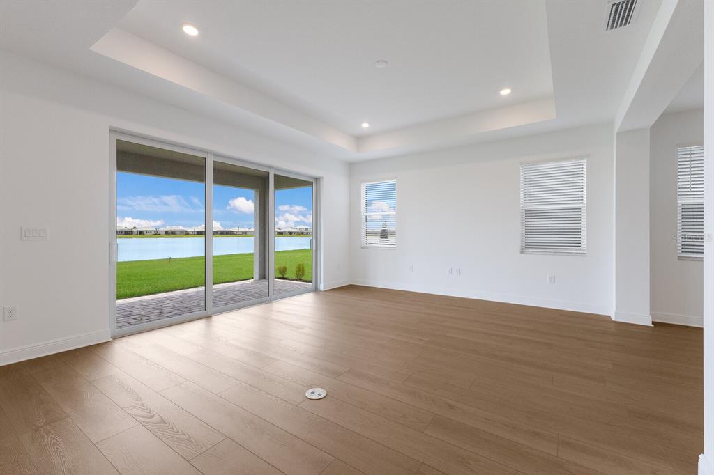 4611 Sweet Retreat Run Lakewood Ranch, FL 34211 - Photo 12 of 37 a view of an empty room with a window and wooden floor