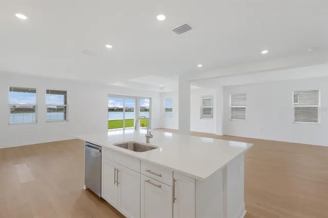 a kitchen with counter top space and windows