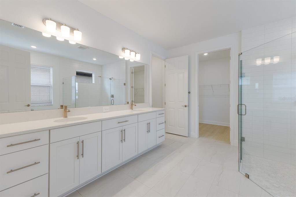 4611 Sweet Retreat Run Lakewood Ranch, FL 34211 - Photo 20 of 37 a spacious bathroom with a double vanity sink mirror and double