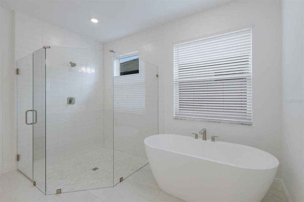 4611 Sweet Retreat Run Lakewood Ranch, FL 34211 - Photo 21 of 37 a white bath tub sitting next to a shower