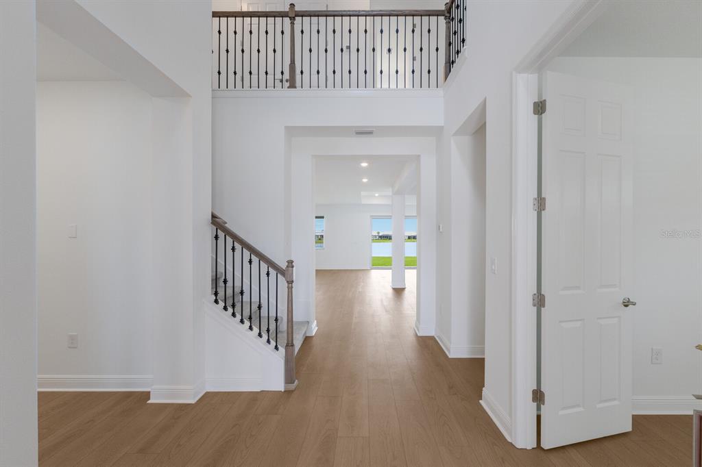 4611 Sweet Retreat Run Lakewood Ranch, FL 34211 - Photo 4 of 37 a view of a hallway with wooden floor and entryway