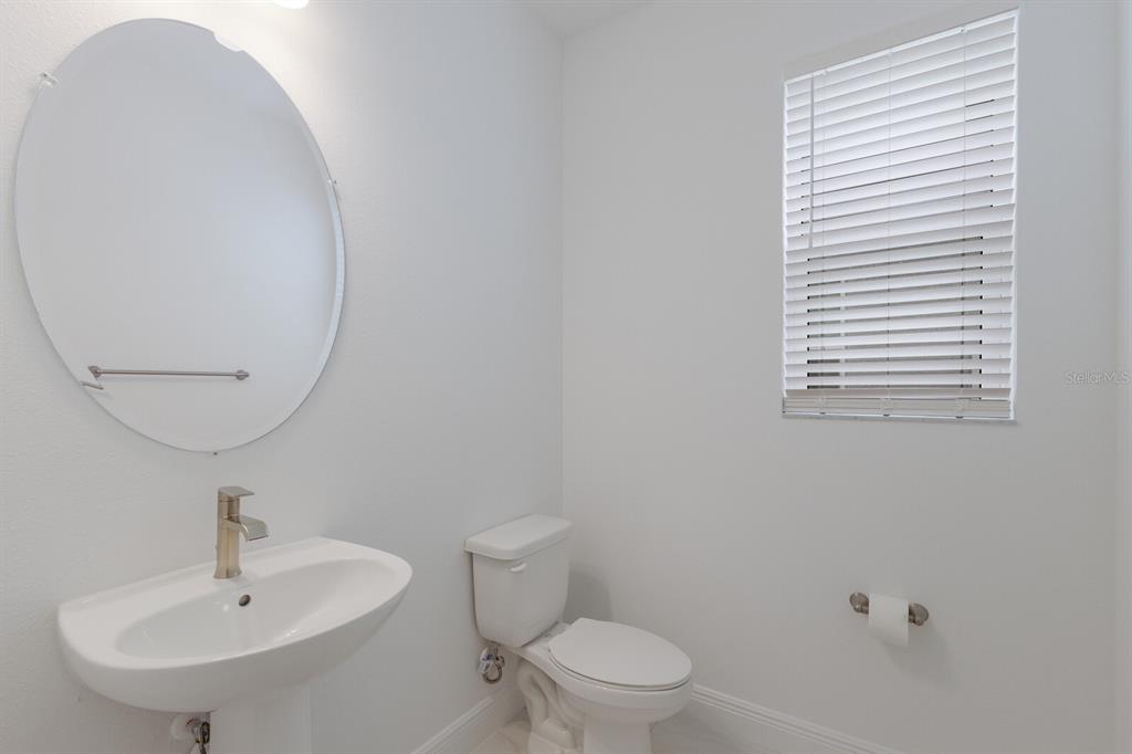 4611 Sweet Retreat Run Lakewood Ranch, FL 34211 - Photo 7 of 37 a bathroom with a sink a mirror and a toilet