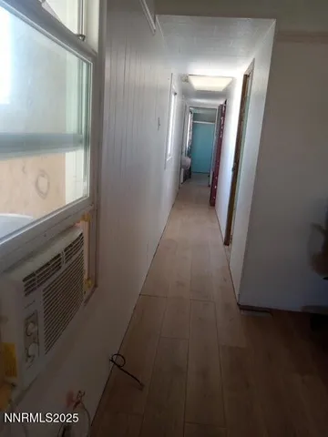 a view of a hallway with wooden floor