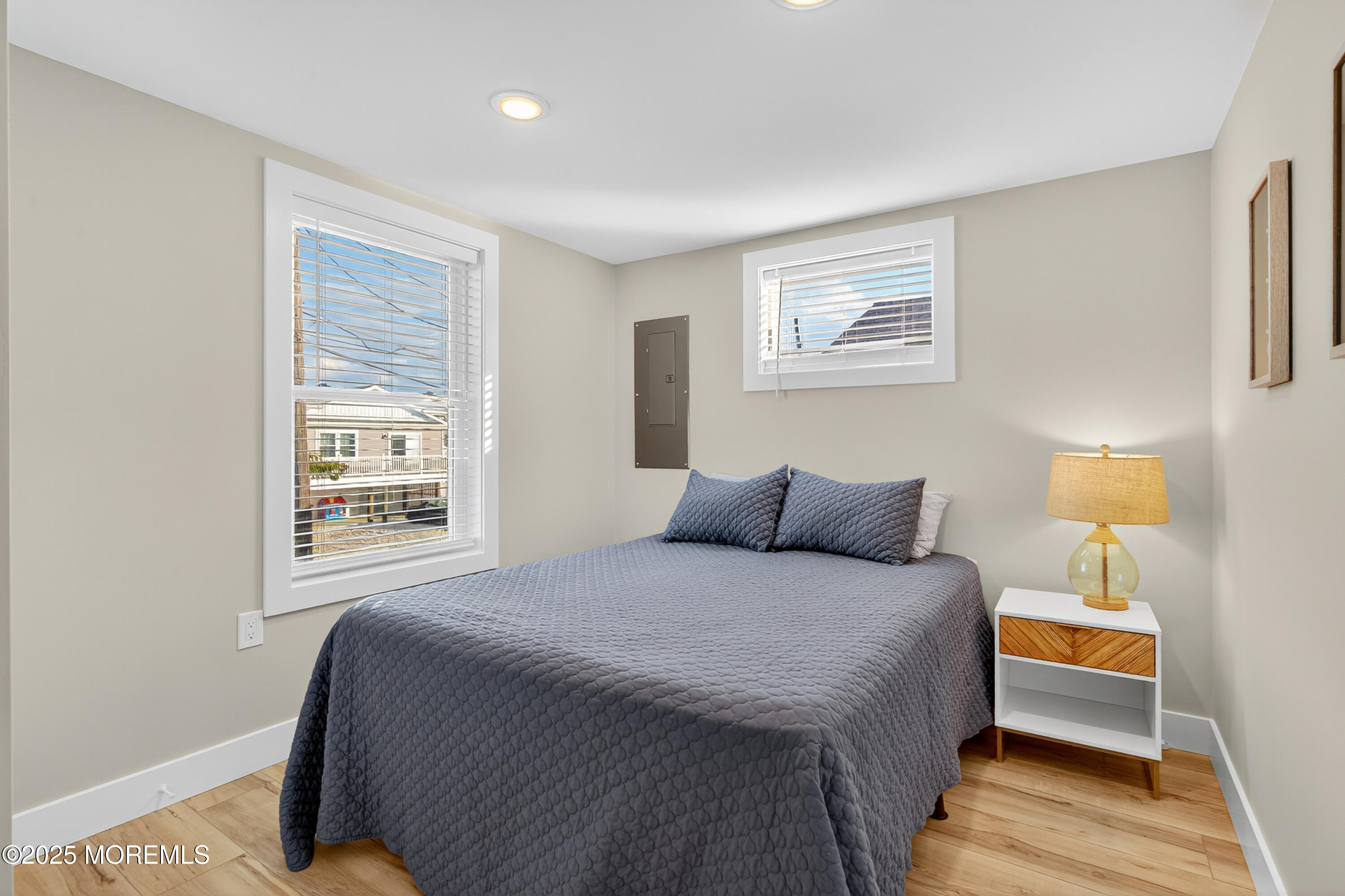 3255 Goa Way Lavallette, NJ 08735 - Photo 19 of 34 a bedroom with a bed and a lamp with wooden floor