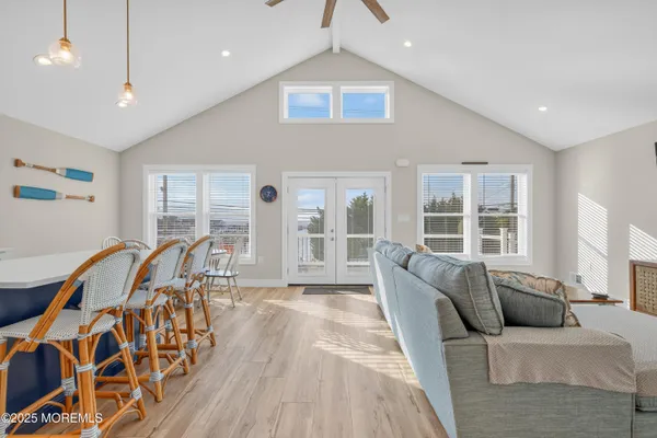 a living room with furniture and a floor to ceiling window