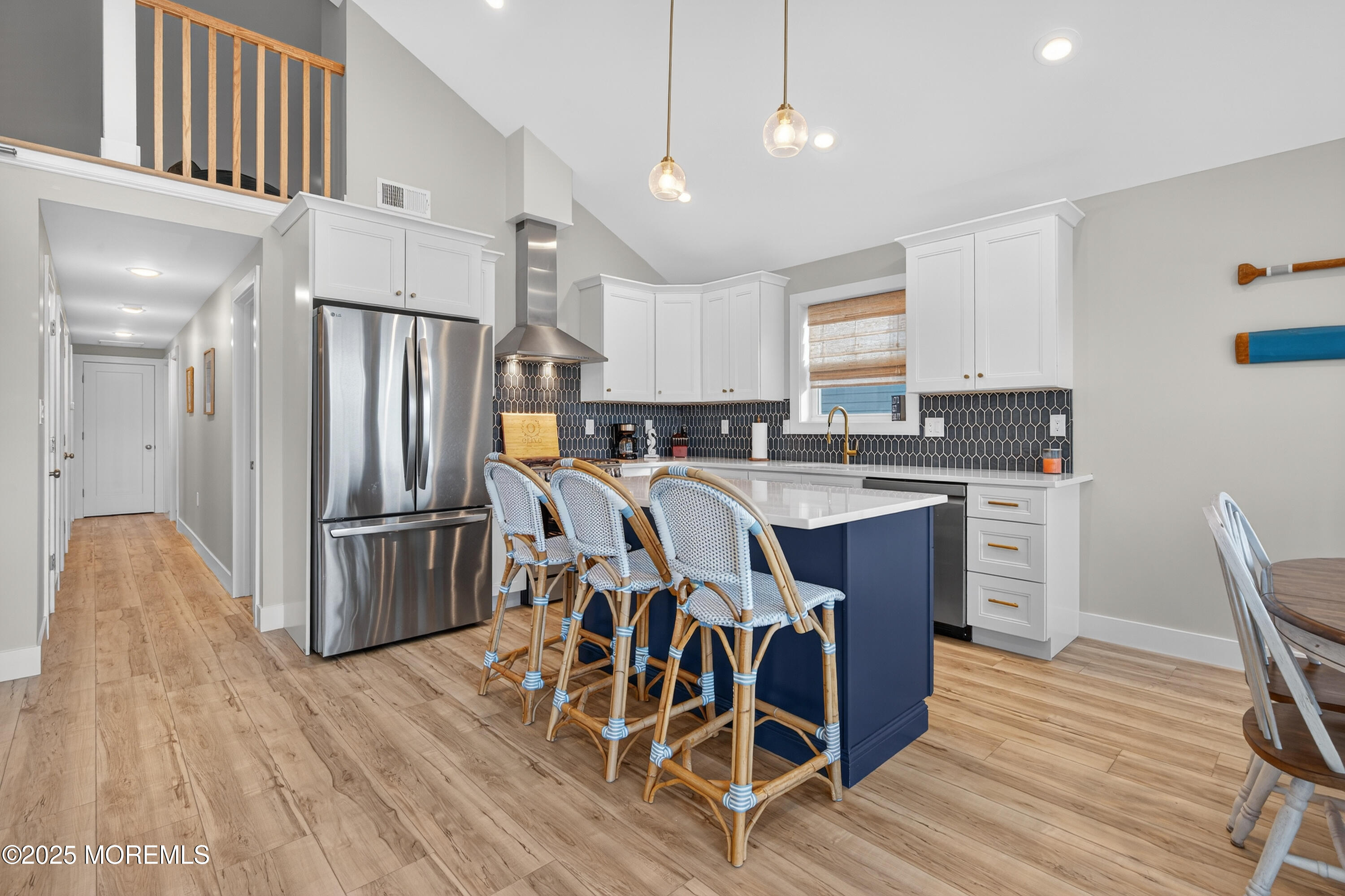 3255 Goa Way Lavallette, NJ 08735 - Photo 10 of 34 a kitchen with stainless steel appliances a refrigerator a stove a sink dishwasher a dining table and chairs with wooden floor