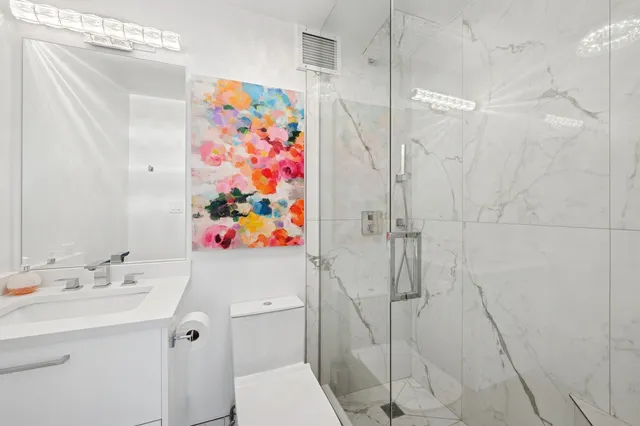 a bathroom with a sink a toilet and shower curtain