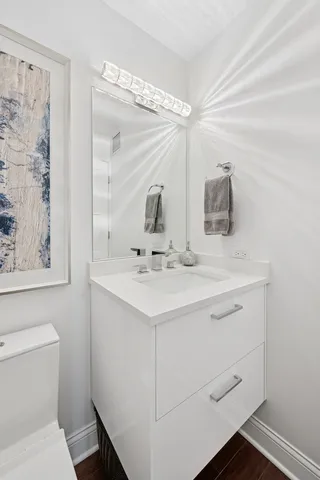 a bathroom with a sink toilet and mirror