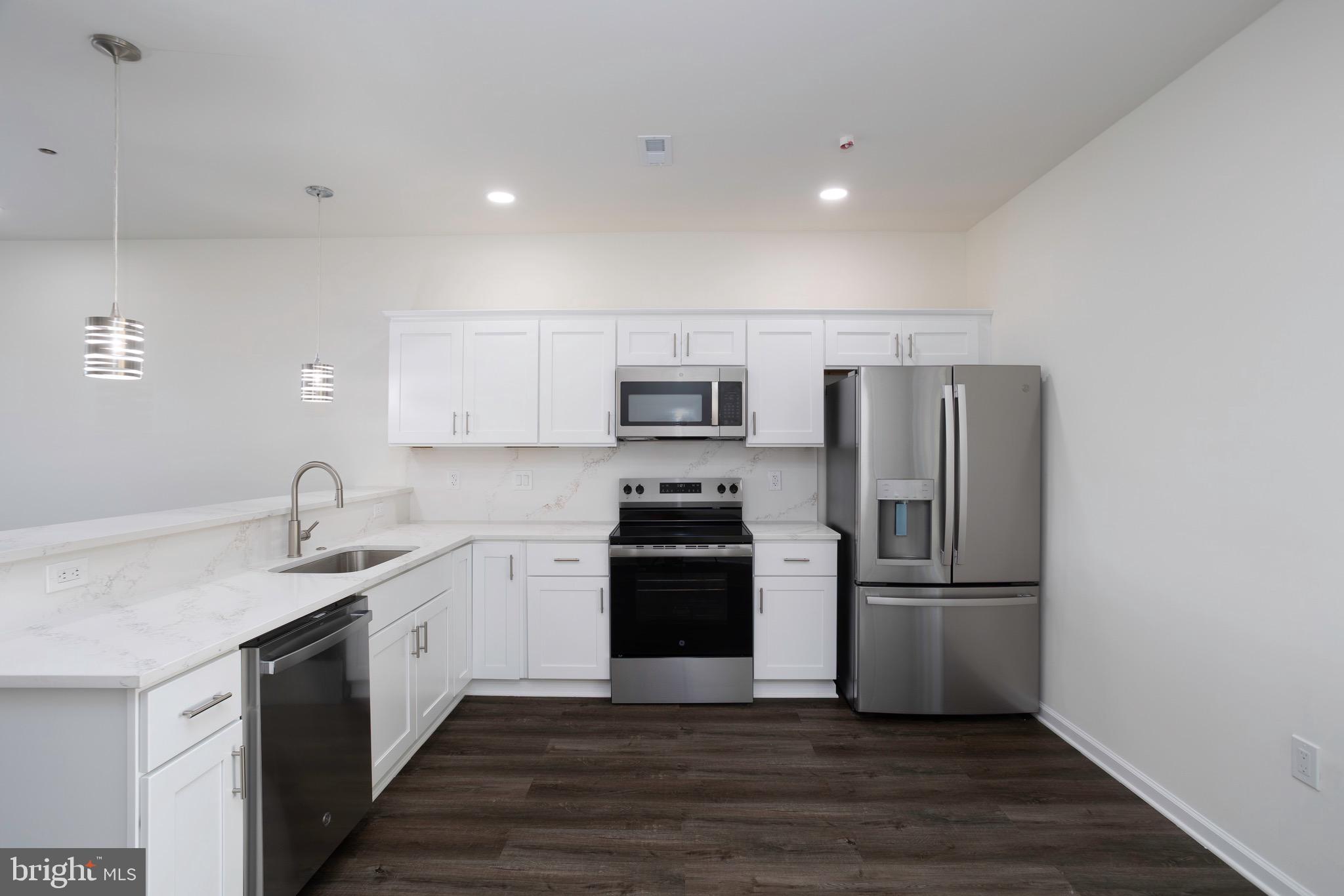 453 Willis Street Cambridge, MD 21613 - Photo 11 of 18 a kitchen with stainless steel appliances granite countertop a sink stove and refrigerator