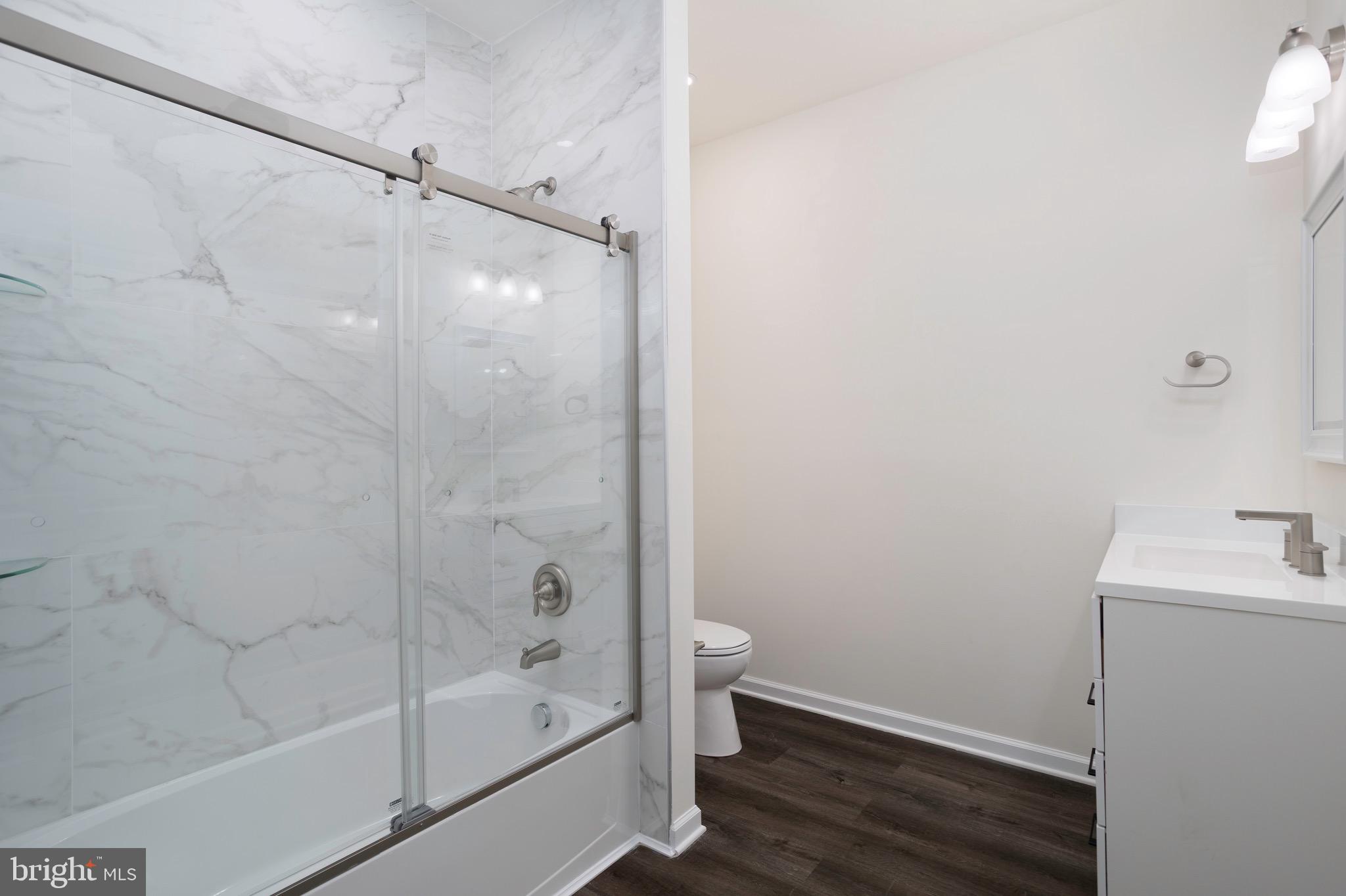 453 Willis Street Cambridge, MD 21613 - Photo 15 of 18 a bathroom with a bathtub and a shower