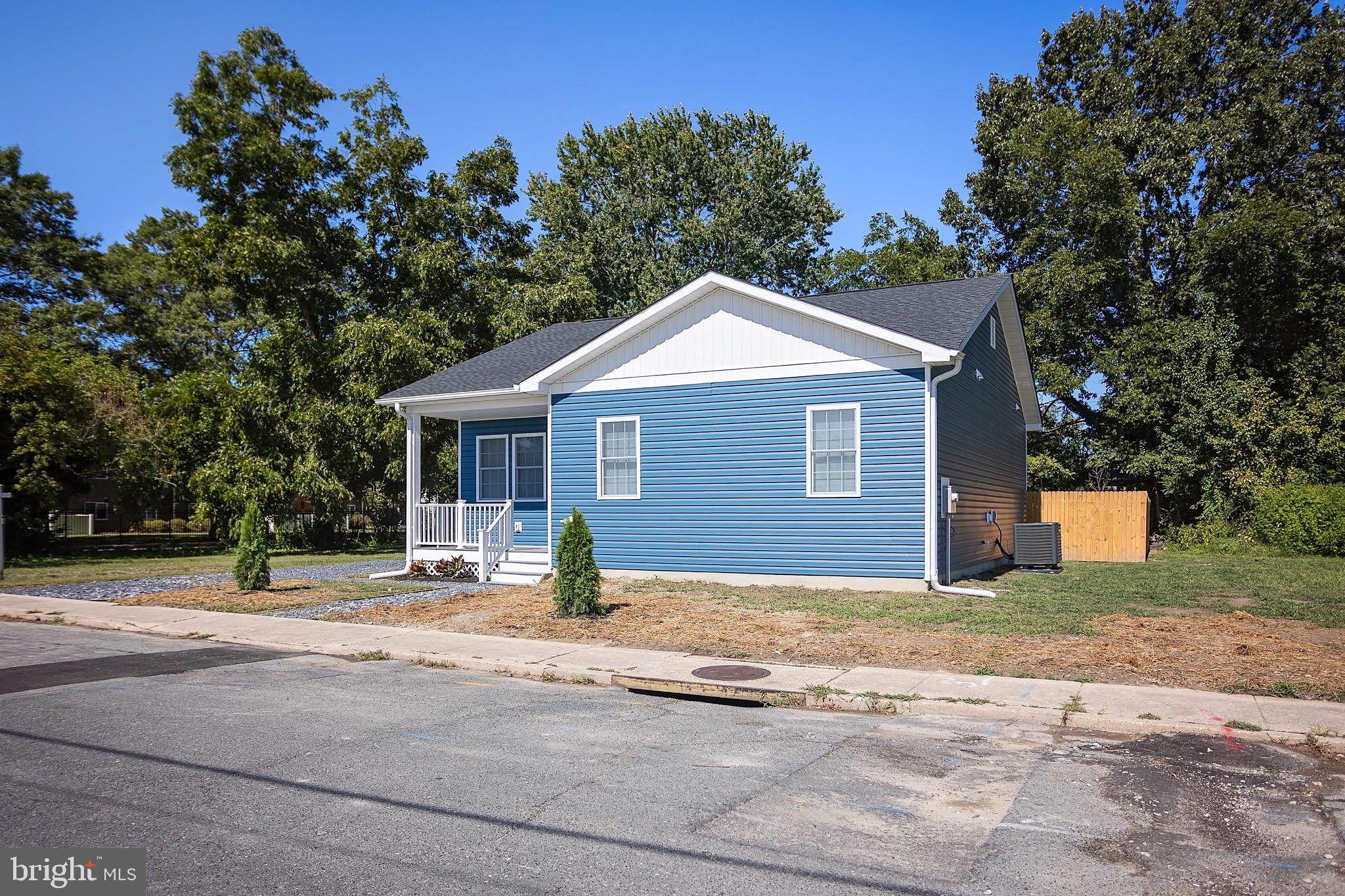 453 Willis Street Cambridge, MD 21613 - Photo 2 of 18 a house with trees in the background