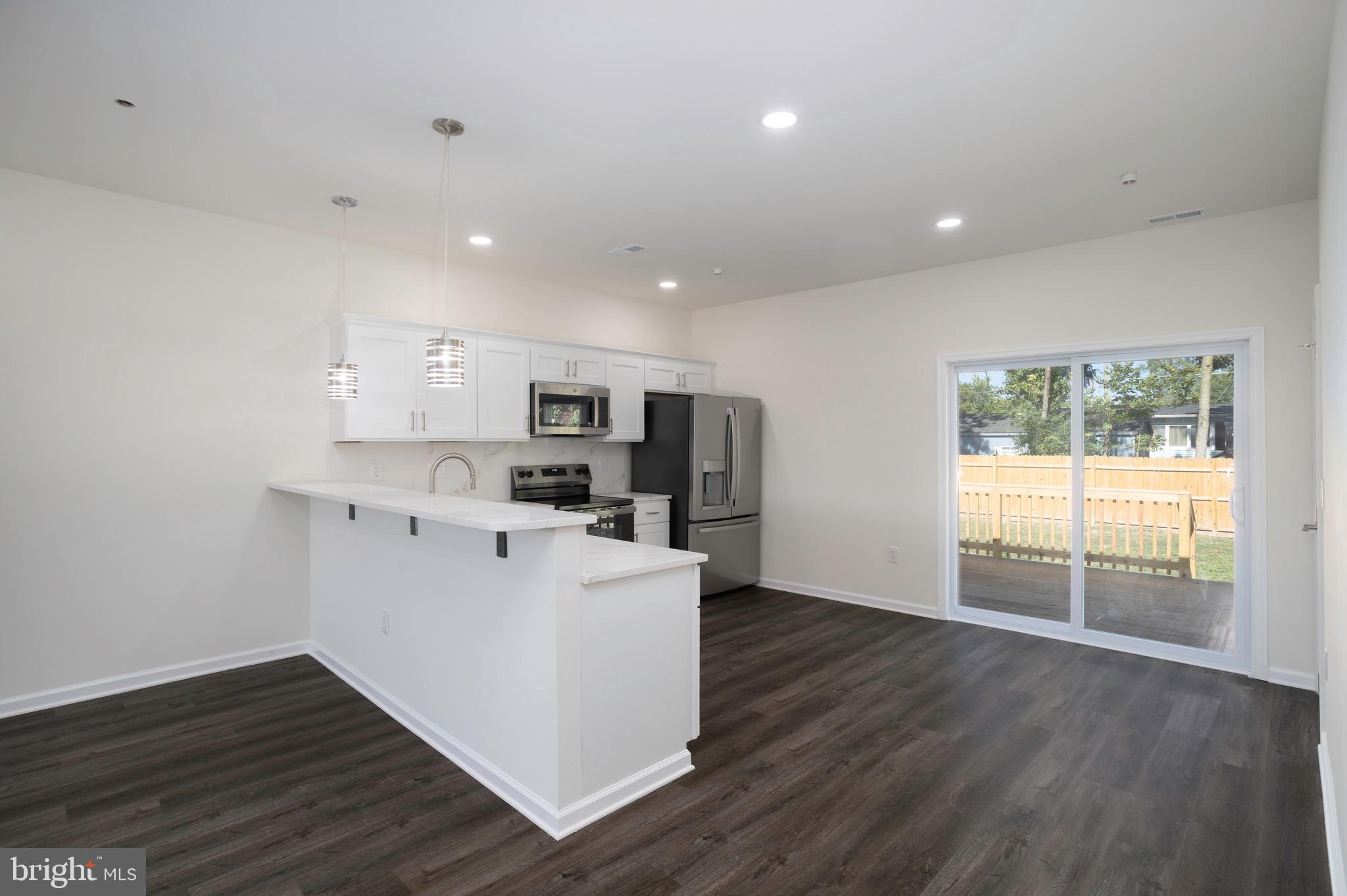 453 Willis Street Cambridge, MD 21613 - Photo 9 of 18 a view of kitchen with wooden floor and electronic appliances