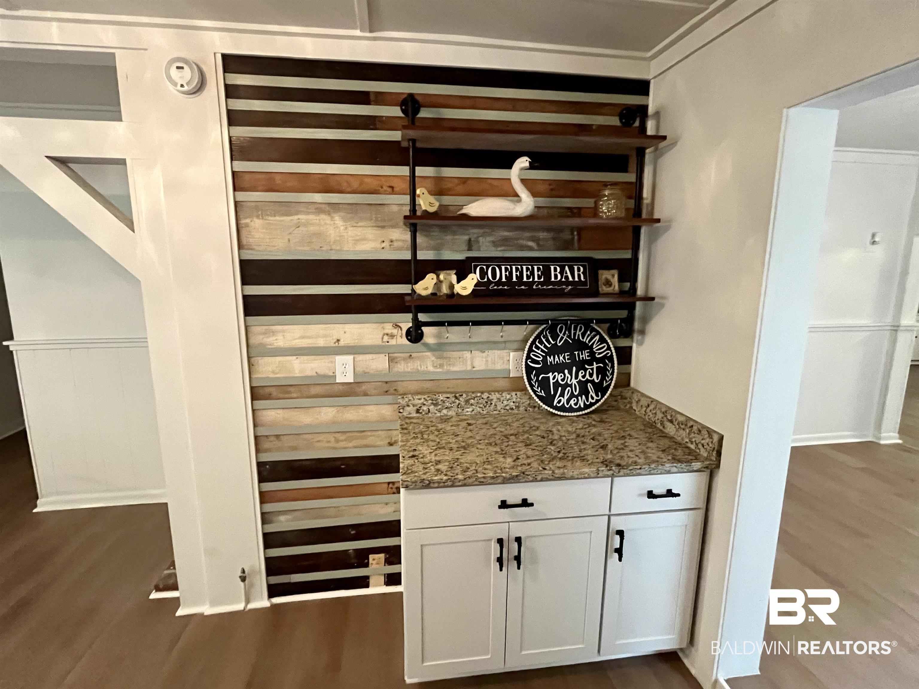 3105 Bryant Road Mobile, AL 36605 - Photo 15 of 39 Built-in cabinetry with a granite-style countertop and a multi-tone wood plank accent wall