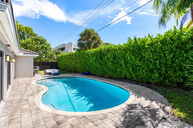 a view of a swimming pool with a yard