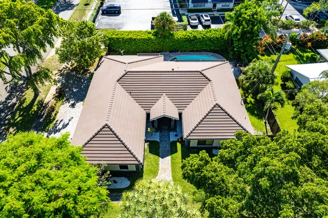 an aerial view of a house with a yard