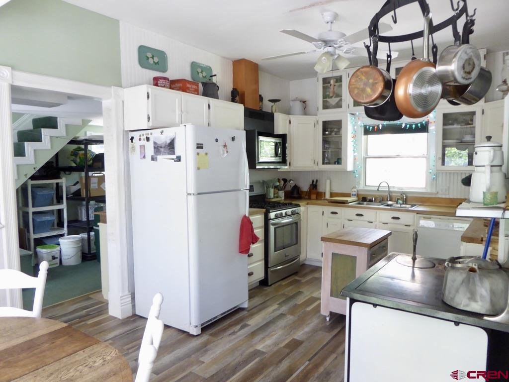2 River Street Silverton, CO 81433 - Photo 13 of 36 a kitchen with stainless steel appliances granite countertop a sink a stove and a refrigerator