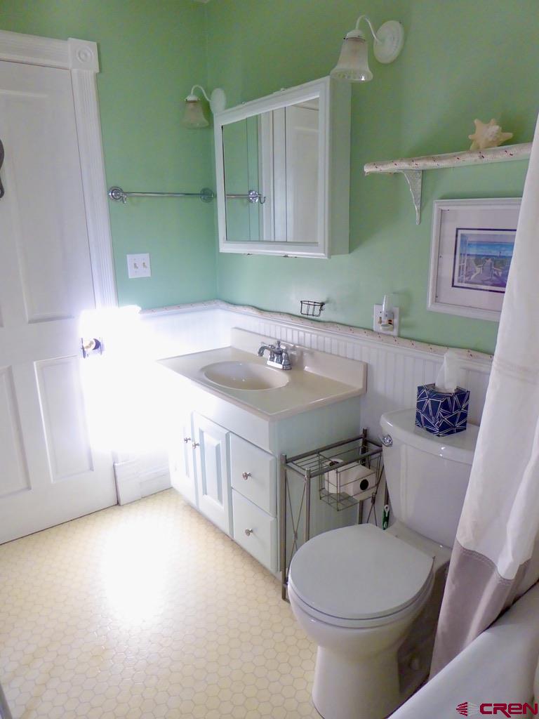 2 River Street Silverton, CO 81433 - Photo 22 of 36 a bathroom with a sink mirror vanity and toilet