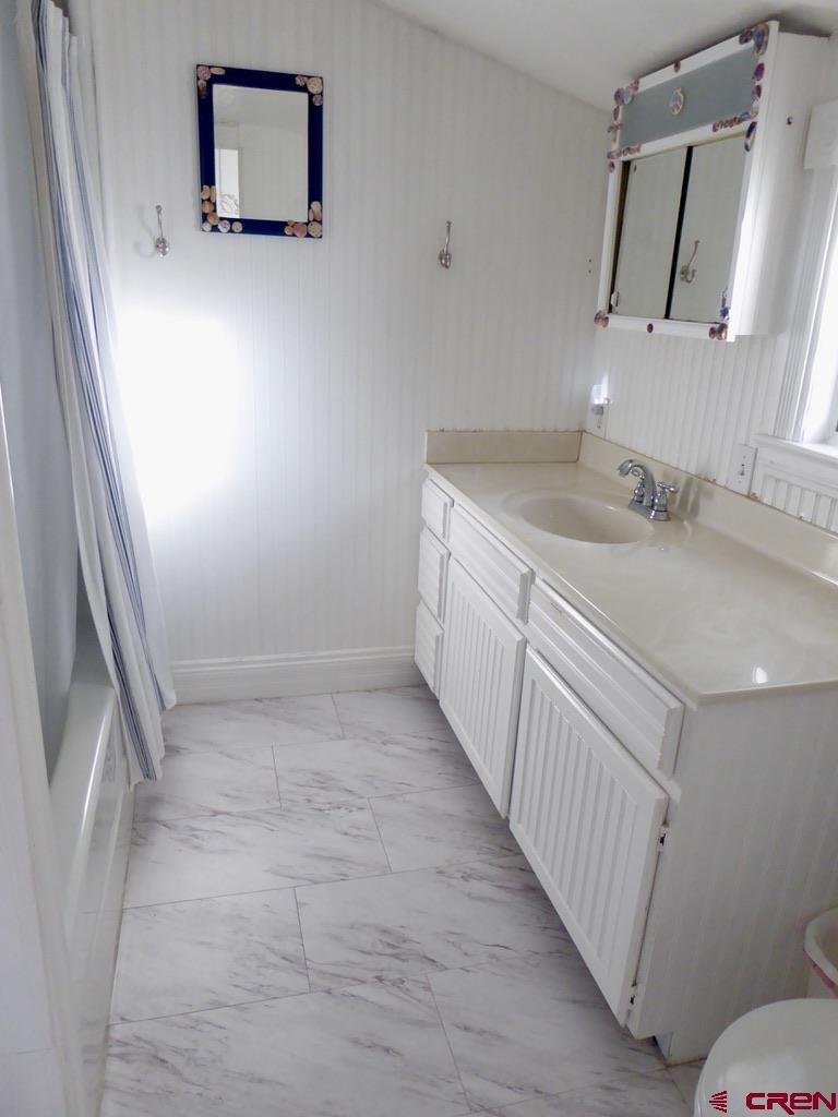 2 River Street Silverton, CO 81433 - Photo 25 of 36 a bathroom with a sink a toilet and mirror