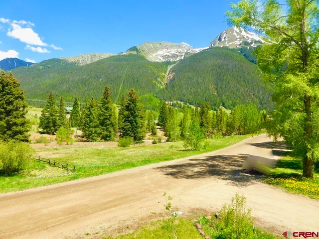 a view of a house with a yard and a lake view