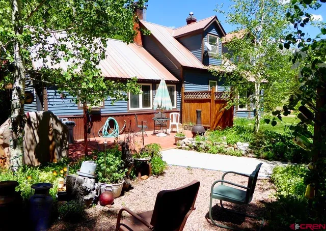 a view of a patio with table and chairs potted plants