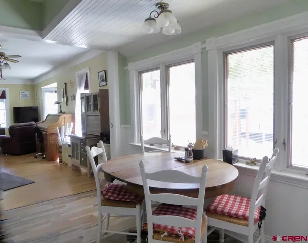 a view of a dining room with furniture window and wooden floor