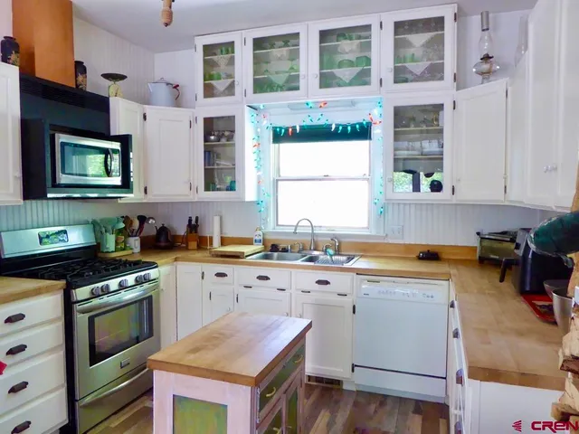 a kitchen with a stove a sink and a microwave