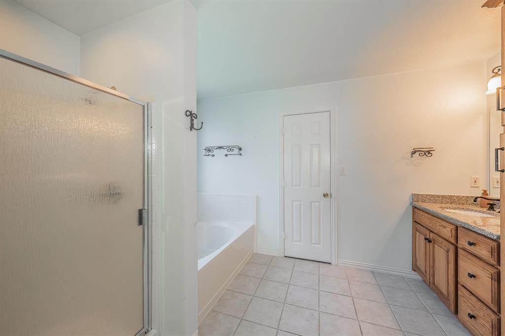 4425 Maple Shade Avenue Sachse, TX 75048 - Photo 22 of 40 a bathroom with a shower and a sink