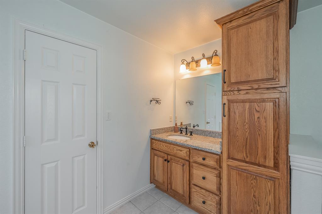4425 Maple Shade Avenue Sachse, TX 75048 - Photo 23 of 40 a spacious bathroom with a double vanity sink and mirror