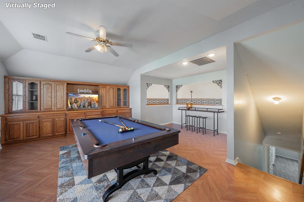 4425 Maple Shade Avenue Sachse, TX 75048 - Photo 25 of 40 a living room with furniture a flat screen tv and a table