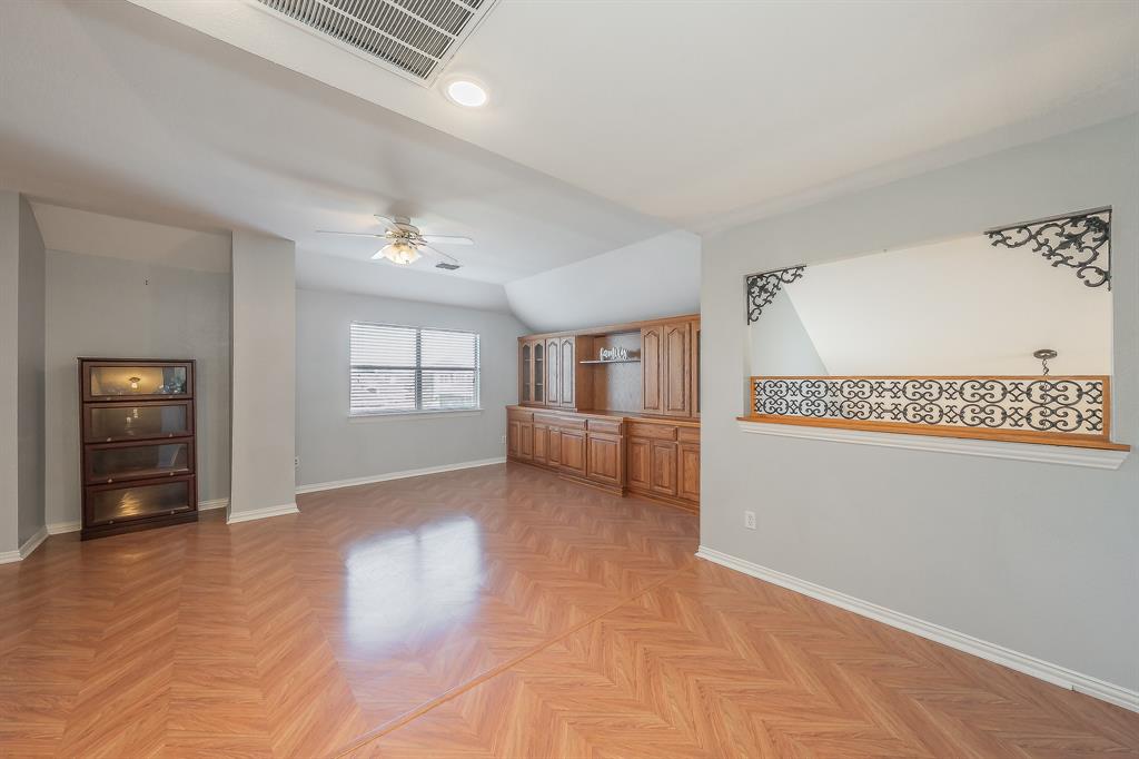 4425 Maple Shade Avenue Sachse, TX 75048 - Photo 26 of 40 a view of a livingroom with wooden floor and a ceiling fan