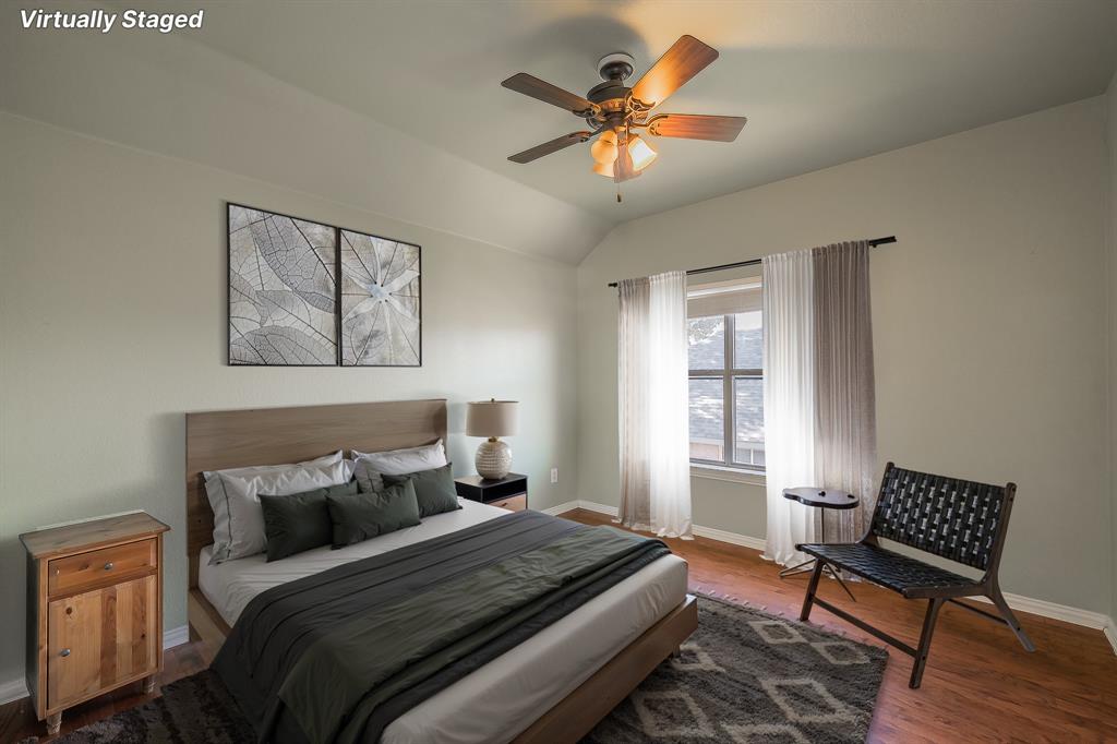 4425 Maple Shade Avenue Sachse, TX 75048 - Photo 28 of 40 a bedroom with a bed and a chandelier
