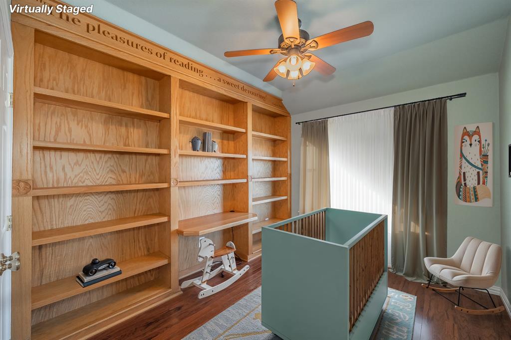 4425 Maple Shade Avenue Sachse, TX 75048 - Photo 29 of 40 a living room with furniture and a book shelf