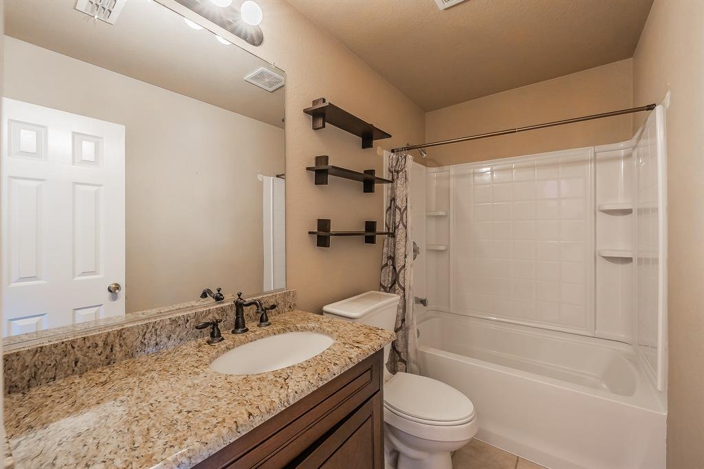 4425 Maple Shade Avenue Sachse, TX 75048 - Photo 30 of 40 a bathroom with a granite countertop sink toilet and shower